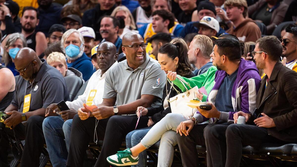 New Sacramento Kings head coach Mike Brown, center, sits courtside to watch his team coached by Jordi Fernandez, Kings head coach during the California Classic, at their NBA preseason basketball game against the Golden State Warriors on Saturday, July 2, 2022, at Chase Center in San Francisco.