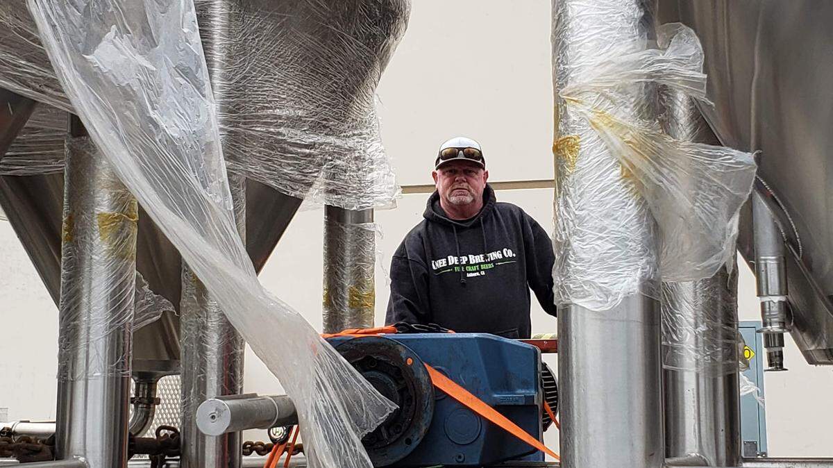 Knee Deep employee Cory Harvey prepares to unload equipment at the brewery’s Auburn home.