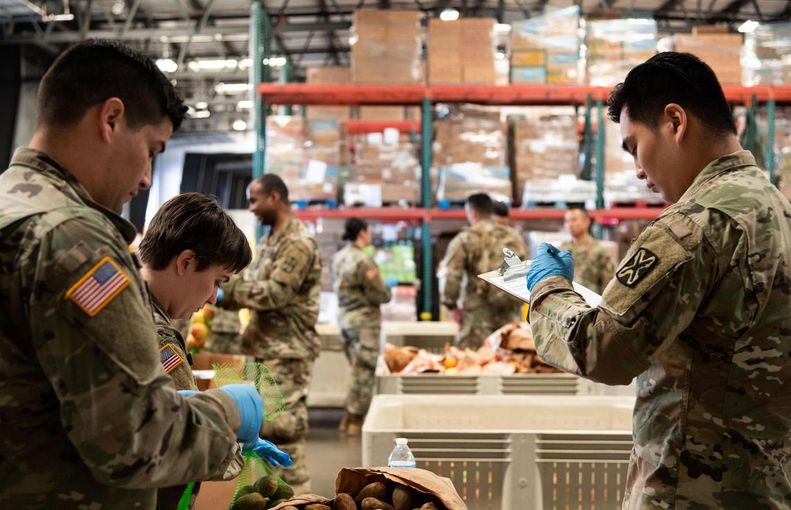 The California National Guard package food at the Sacramento Food Bank on Saturday, March 21, 2020, in North Sacramento. Staff at the food bank said many of their regular volunteers are older, which fall into a higher-risk category for the coronavirus. They added that the National Guard packed 1,493 boxes — a little over 37 pallets — in just six hours, well ahead of their normal output.