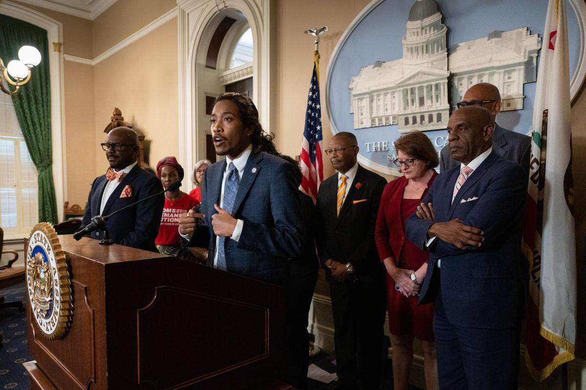 Tennessee Rep. Justin Jones speaks during a press conference surrounded by California state legislators at the state Capitol on Monday. Jones was expelled in April along with fellow Democrat Rep. Justin Pearson from the GOP-dominated Tennessee General Assembly after a pro-gun control demonstration on the House floor. Assemblyman Mike A. Gipson, whose resolution condemning the expulsions passed 60-0 in the Assembly on Monday, stands at left.