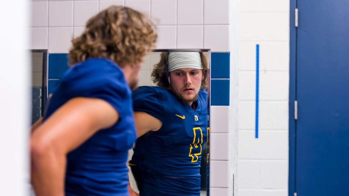 Oak Ridge High School Trojans Matt Jenner (4), check himself in the mirror as he gets ready inside the locker room before the game as the Oak Ridge High School Trojans host the Vacaville High School Bulldogs, Friday Aug 24, 2018. photo by Brian Baer