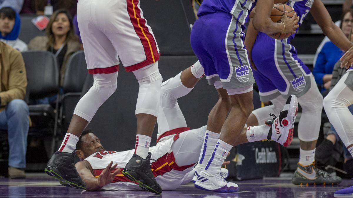 Miami Heat guard Dwyane Wade falls and hits his head after driving to the basket in the first half Friday at Golden 1 Center. He later returned to the game.