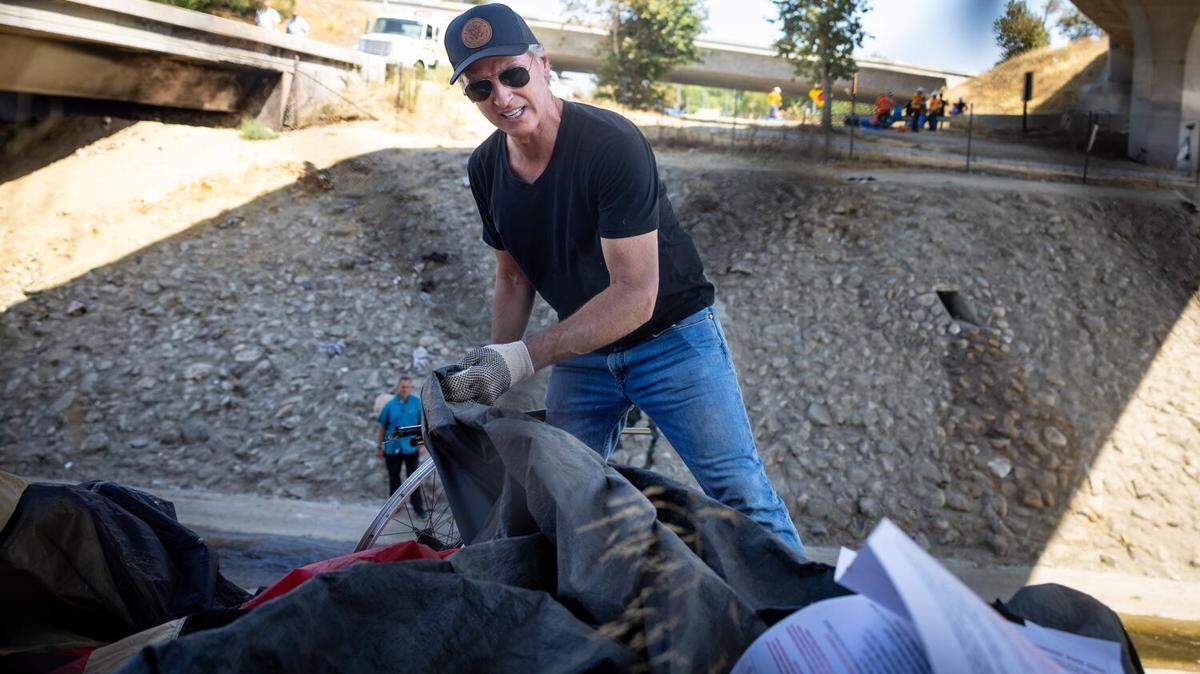 Gov. Gavin Newsom joins Caltrans workers to clean up an encampment site near Paxton Street and Remick Avenue in Los Angeles on Thursday, Aug. 8, 2024.
