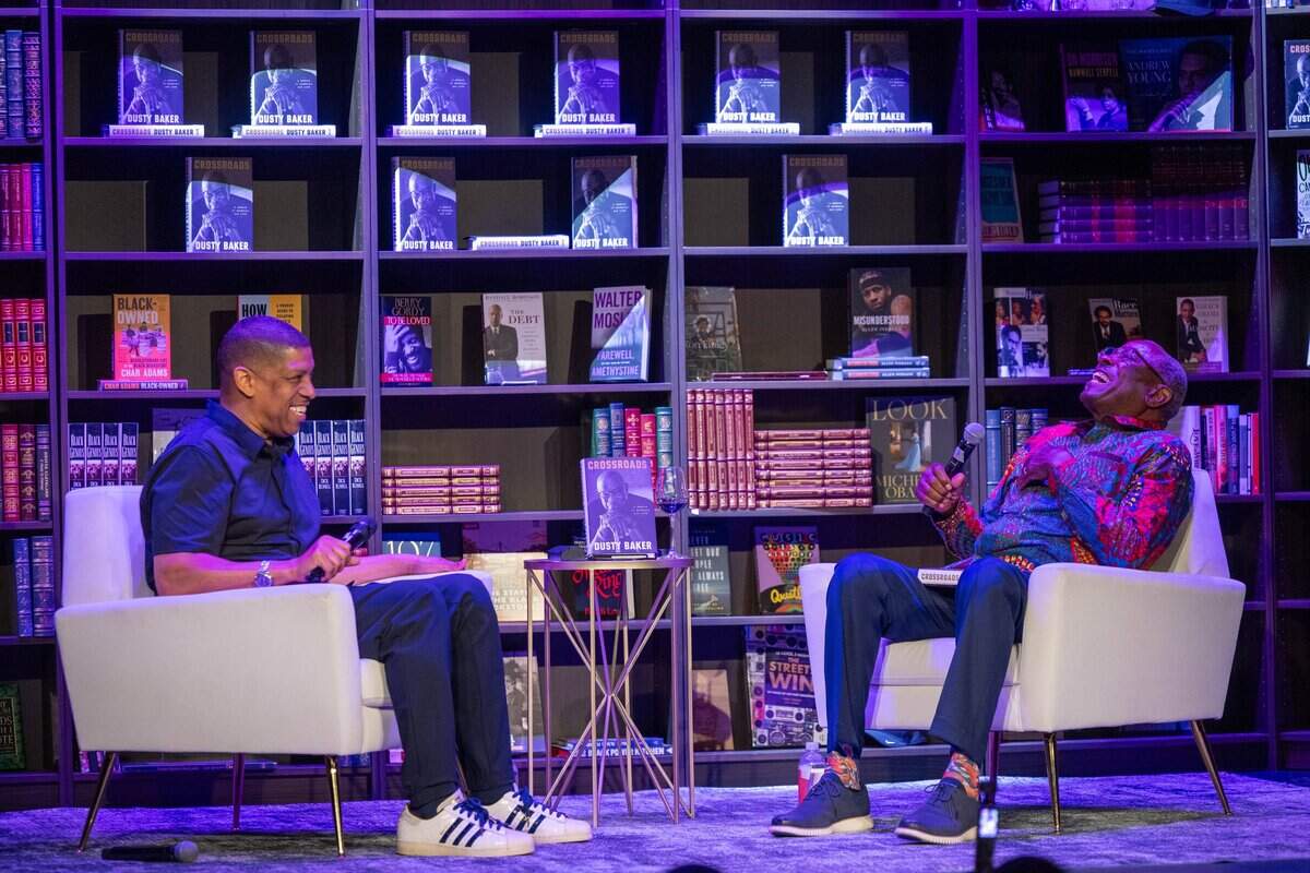 Former Sacramento Mayor Kevin Johnson, left, speaks with Dusty Baker about Baker’s memoir "Crossroads" during an event at The Guild Theater in Sacramento on Monday.