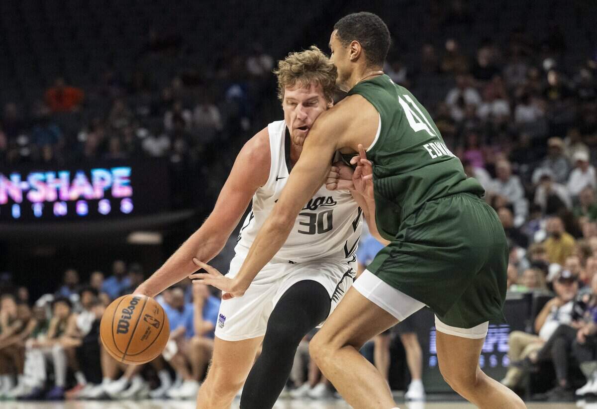 Sacramento Kings forward Victor Lakhin (30) is guarded by Milwaukee Bucks Center Jesse Edwards (41) during the California Classic game at Golden 1 Center on Monday.