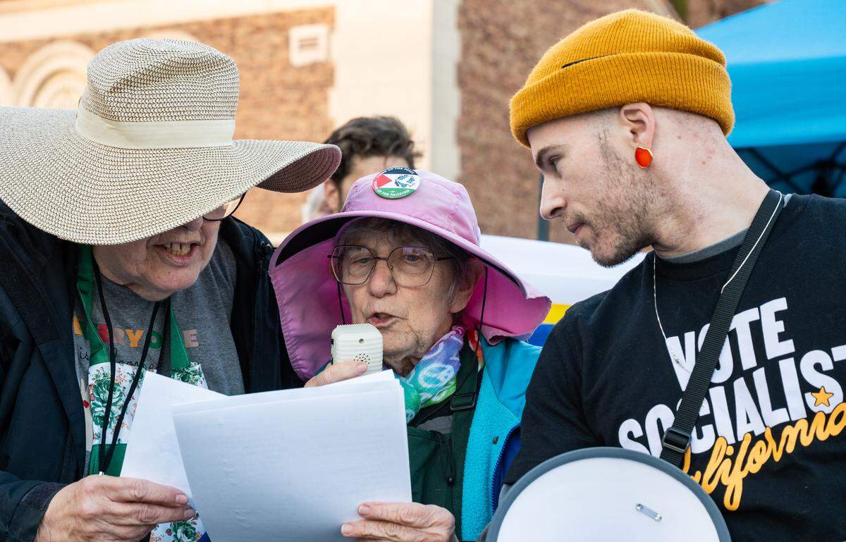 Ellen Schwartz, center, a member of the Raging Grannies of Sacramento, sings a song in protest on Saturday during a demonstration against U.S. military action in Venezuela.