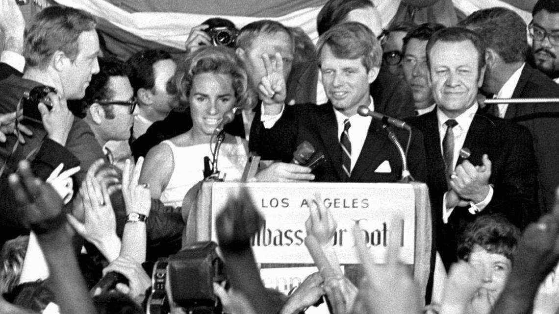 This June 5, 1968 file photo shows Sen. Robert F. Kennedy speaking his final words to supporters at the Ambassador Hotel in Los Angeles, moments before he was shot. At his side are his wife, Ethel, left, and his California campaign manager, Jesse Unruh, right.