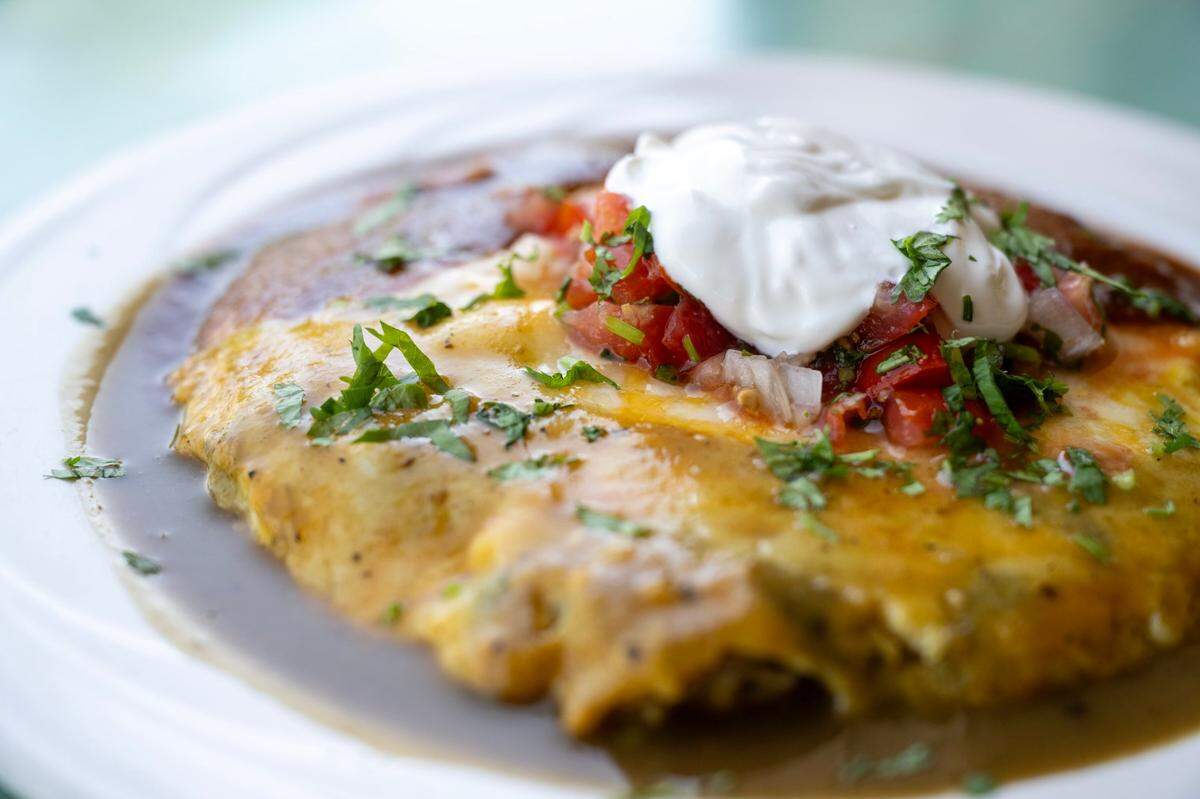 The Nopalitos Quesadilla, a flour tortilla stuffed with cheese, roasted poblano chilies and cactus, is served with mild salsa, sour cream and guacamole at the East Sacramento restaurant on Sept. 16, 2024.