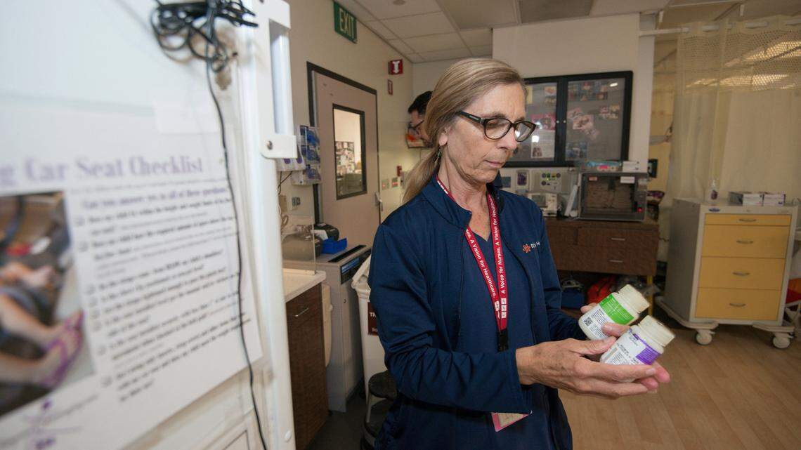 Diane Bell-Gardiner, a registered nurse at Mercy Medical Center, who lost her home in the Carr Fire, works at her job in the Neonatal Intensive Care Unit in Redding, Calif., Thursday, Aug. 2, 2018. Bell-Gardiner is one of dozens of staff members, including doctors, nurses and others at Dignity Health Mercy Medical Center in Redding without homes who are coming to work to keep the hospital running. (AP Photo/Michael Burke)
