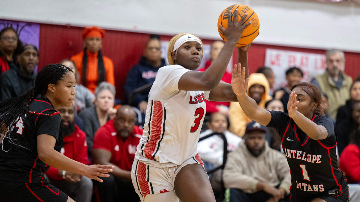 The McClatchy Lions’ Norret Lewis (3) drives past Antelope Titans defenders in the first half of a CIF Sac-Joaquin Section Division I playoff game Thursday in Sacramento.