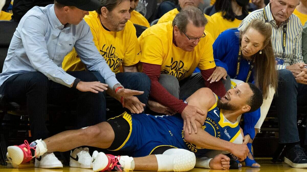 Golden State Warriors guard Stephen Curry (30) lies on ground after being fouled by Sacramento Kings guard Kevin Huerter during Game 6 of the first-round NBA playoff series at Chase Center on Friday.