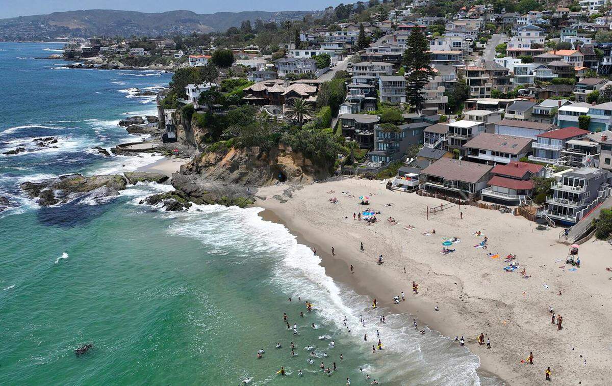 Beach-goers enjoy Victoria Beach in Laguna Beach on June 20.