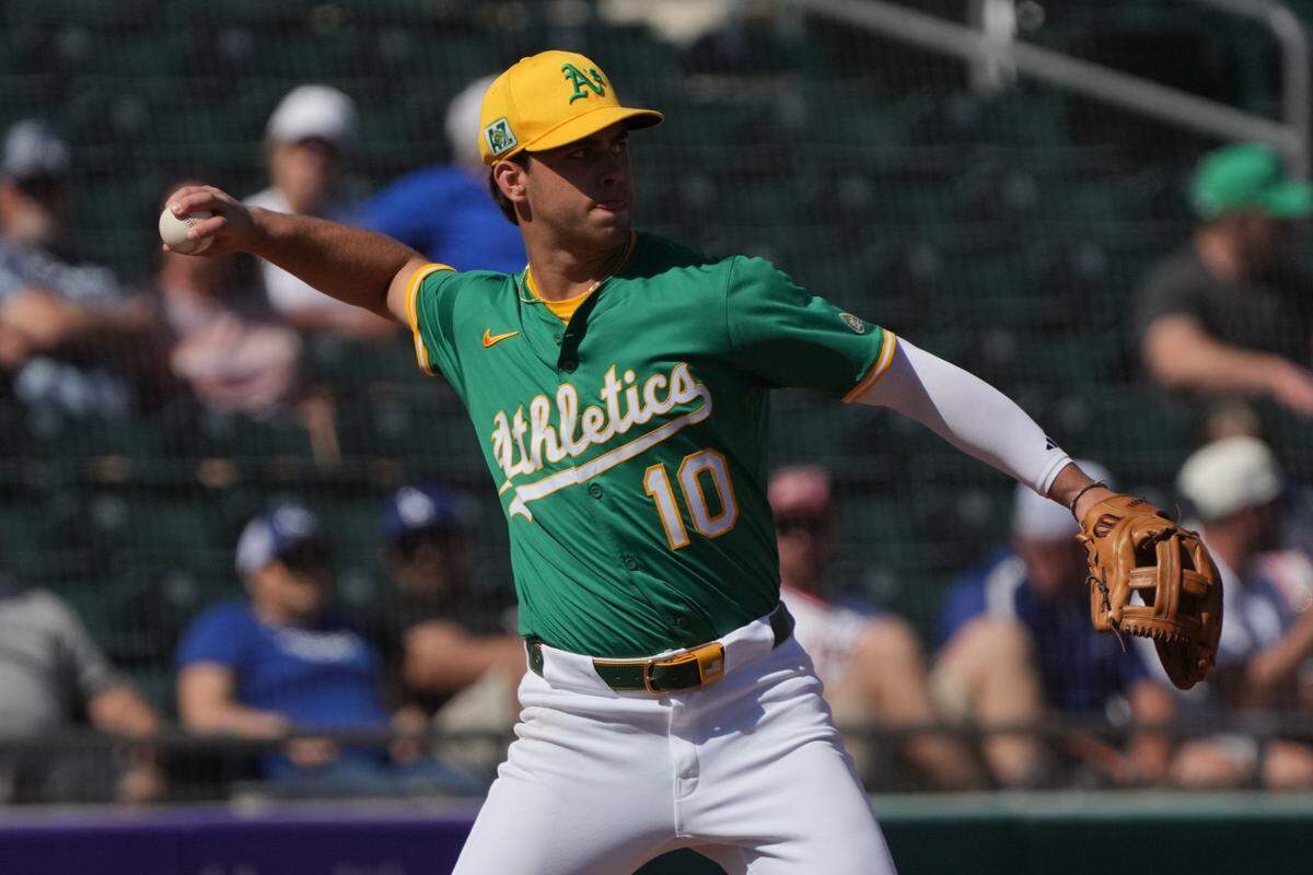 Mar 2, 2025; Mesa, Arizona, USA; Oakland Athletics Max Muncy makes the play for an out against the Los Angeles Dodgers  in the third inning at Hohokam Stadium. Mandatory Credit: Rick Scuteri-Imagn Images