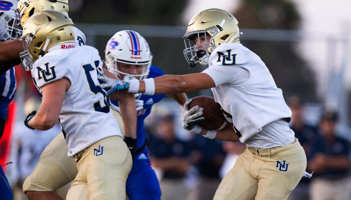 The Nevada Union Miners' Rhyder Eelkema (3) follows the block of lineman Tristan Rohde (50) to pick up yards against the Christian Brothers Falcons in Sacramento on Friday.