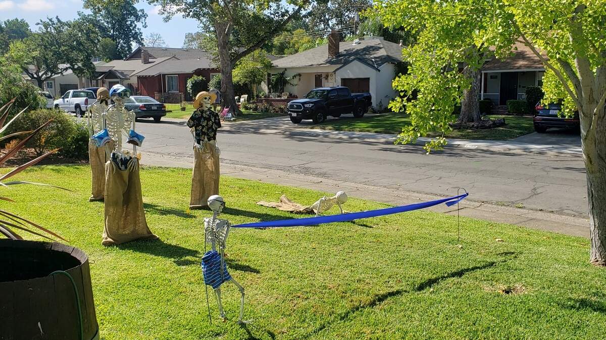 A group of plastic skeletons are competing in a sack race outside the Abernathy family’s East Sacramento home.