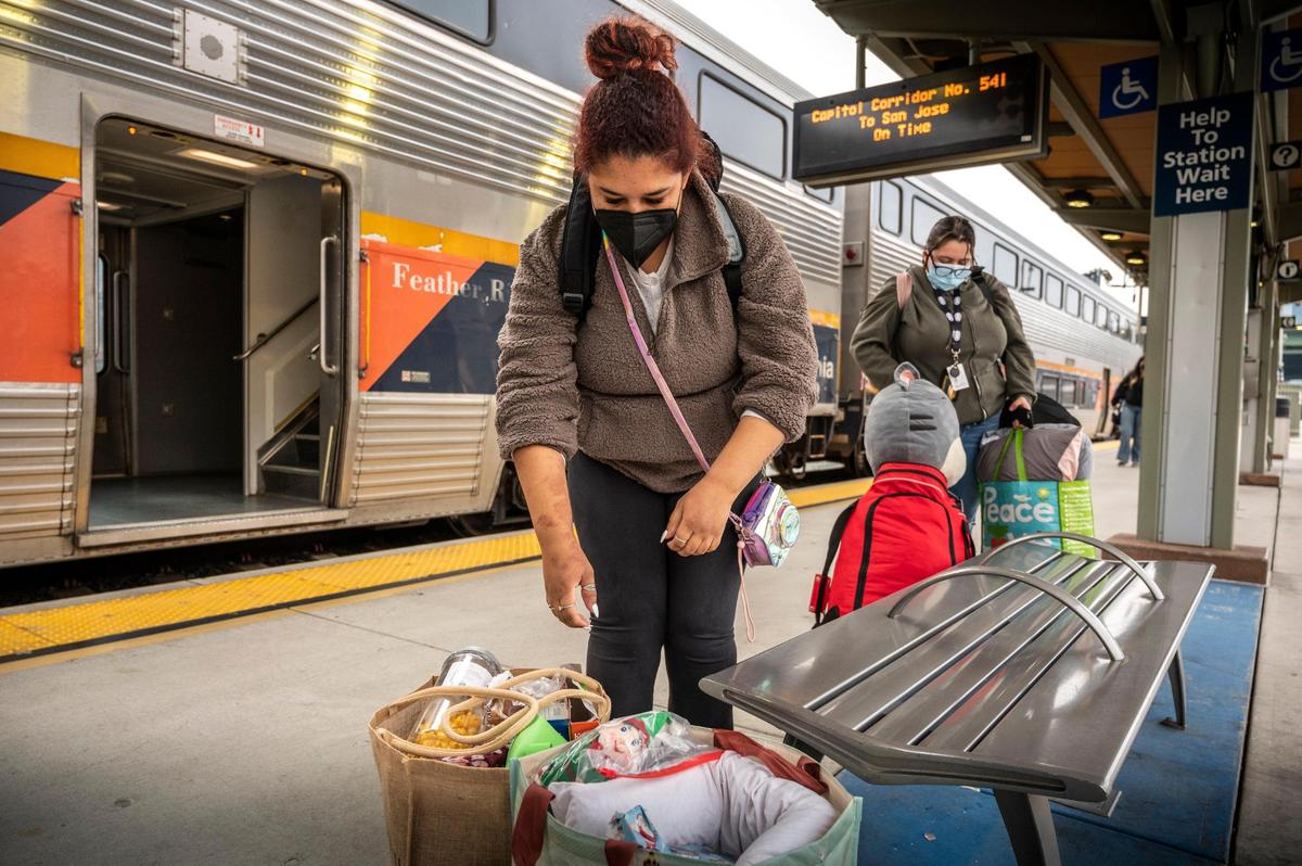 Allie Boucher and her friend Marta Aranda, both Sacramento State students, get ready to board the Capitol Corridor on Tuesday at the Sacramento Valley Station. Aranda will be spending the holidays with her friend’s family in Suisun. Boucher said that they took the train because they don’t drive and “It’s easier and more convenient.”