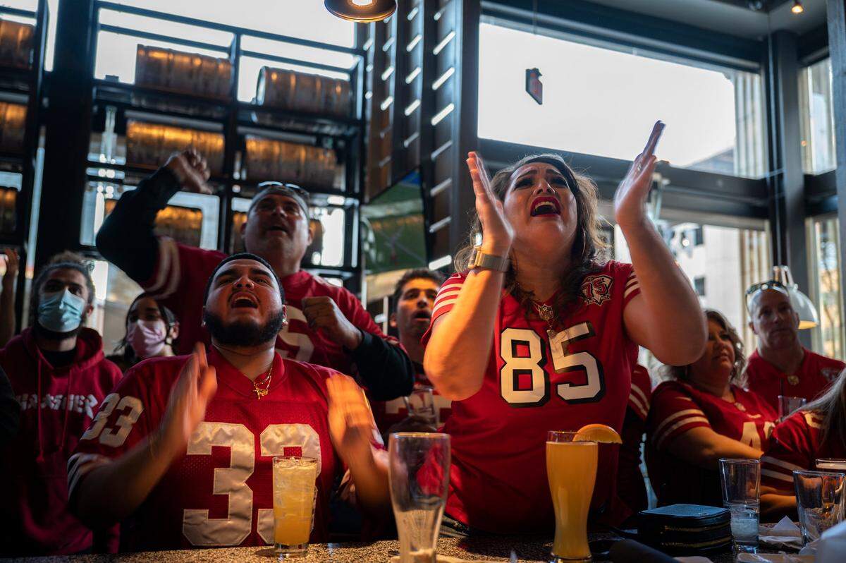 Junior Rosado, left, and Salina Majorca react during the NFC Championship game between the 49ers and Rams in 2022, at Public House Downtown. The Sacramento bar served as a hub for Northern California sports fans.