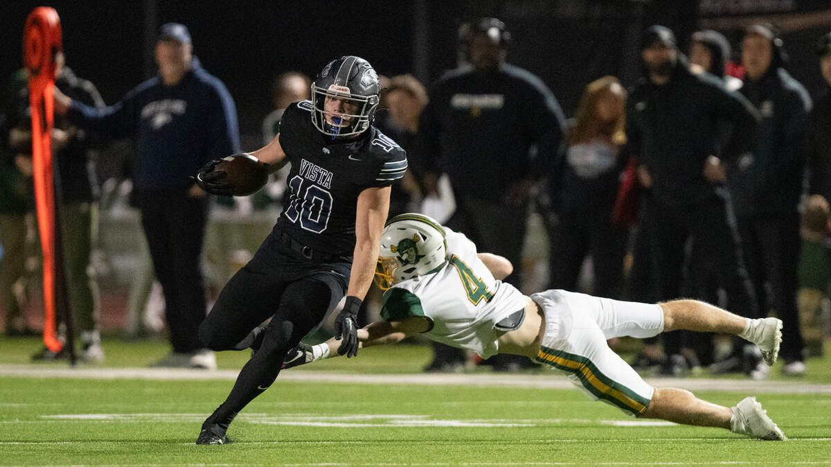 Vista del Lago Eagles receiver Matt Long (10) evades the Rio Americano Raiders’ Chase Carry (4) on his way to a 60-yard touchdown in the first quarter of a CIF Sac-Joaquin Section Division IV playoff quarterfinal Friday.