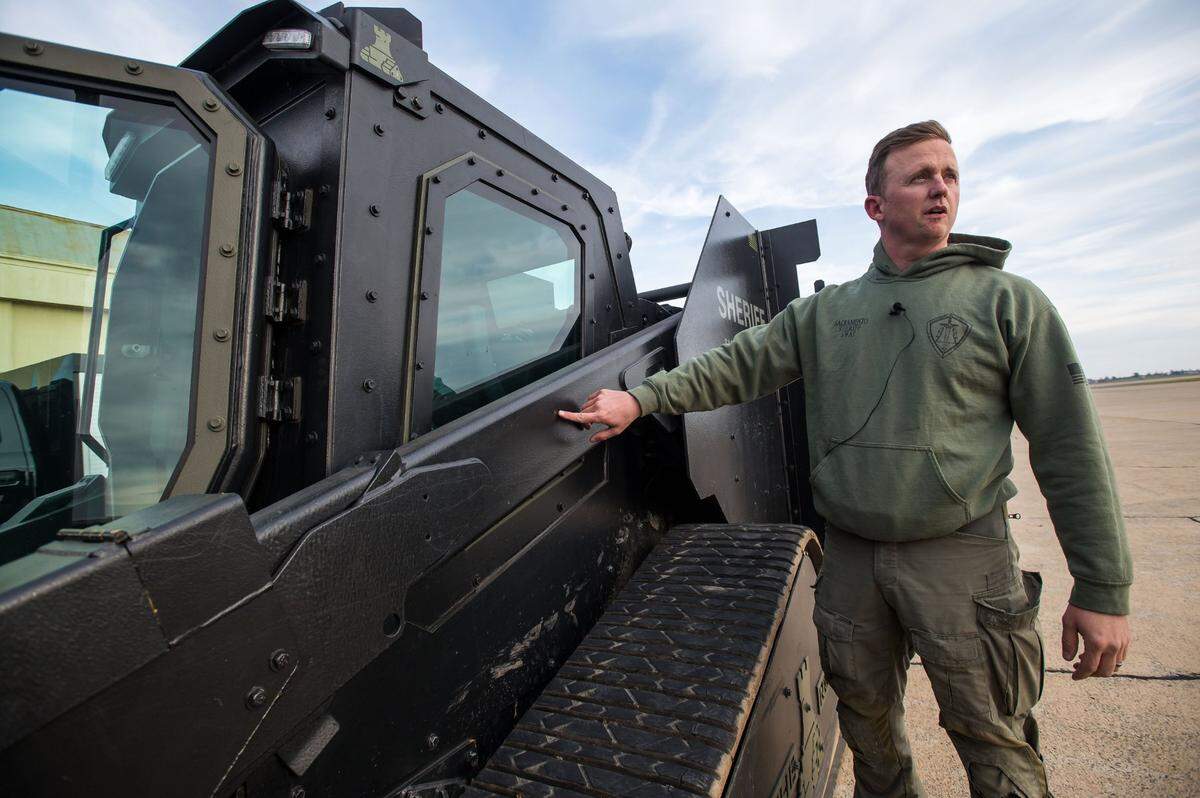 Sacramento County Sheriff’s Deputy Ken Becker, a member of the SWAT team, points Thursday, Feb. 16, 2023, to the impact point of a deflected bullet on the department’s Rook. The armored vehicle is based on a Caterpillar skid steer loader.