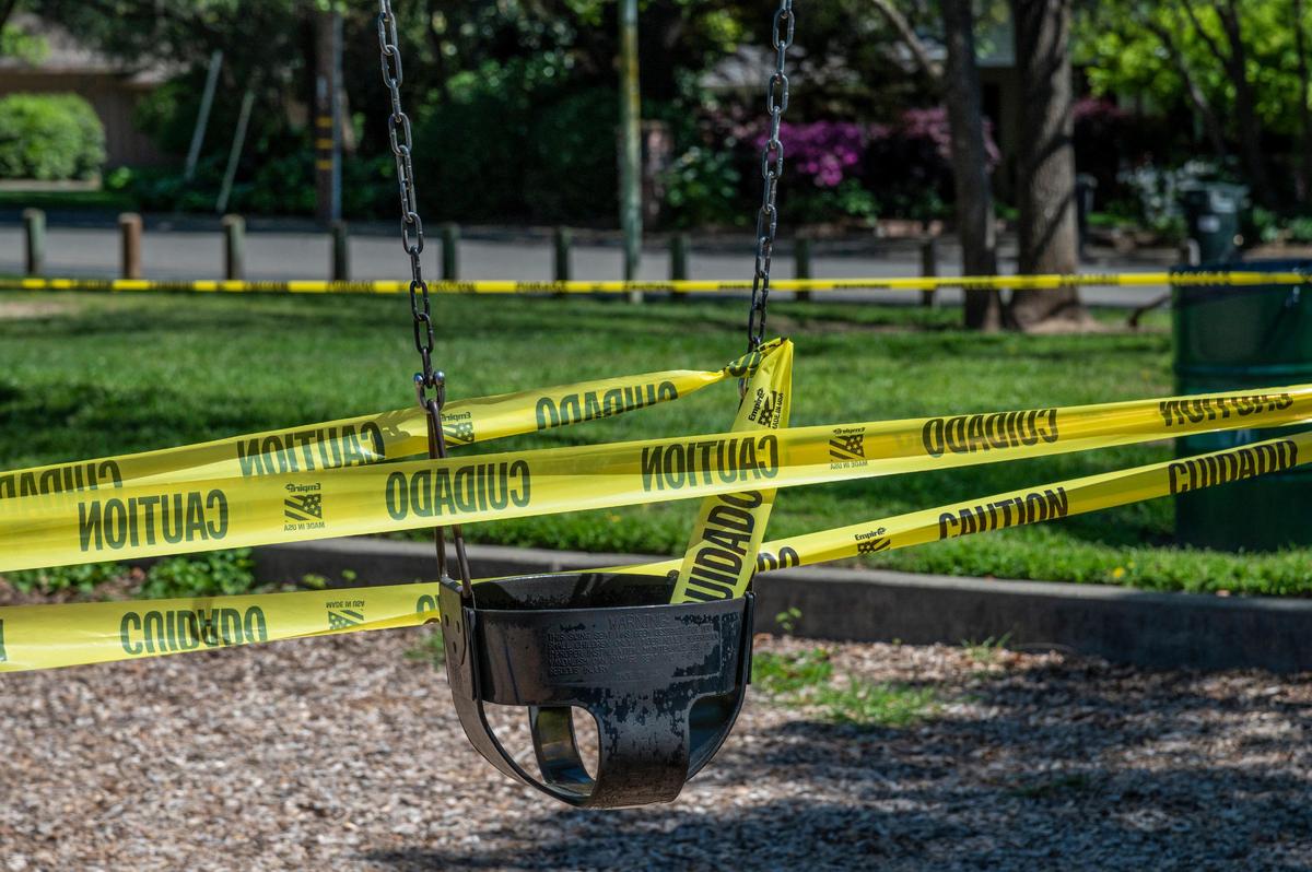 Shelfield Park Mission Oaks recreation and park district used yellow tape to keep children from the playground in Carmichael on Tuesday, March 31, 2020. Warning signs read: “Mission Oaks Parks are currently remaining open. However, per California department of Health recommendation due to the COVID-19 (coronavirus) we are asking that all park patrons keep a safe distance of six feet and abstain from unnecessary physical contact.”