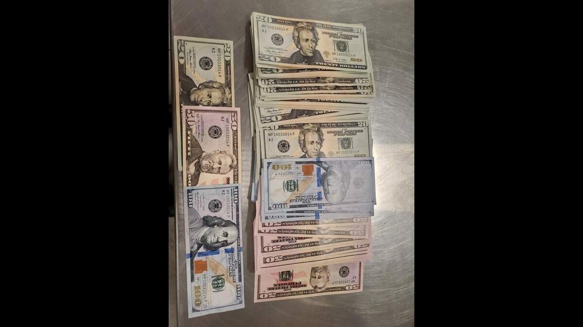 Counterfeit money found near an El Dorado Hills grocery store is seen. A bag contained fake $20, $50 and $100 bills.
