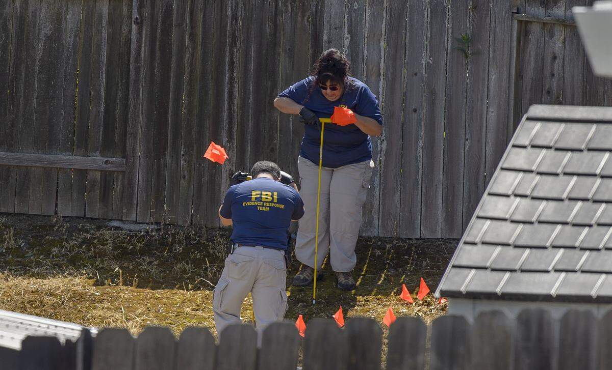 Law enforcement authorities push long probes into the dirt in the backyard of the suspected East Area Rapist in Citrus Heights on Wednesday, April 25.