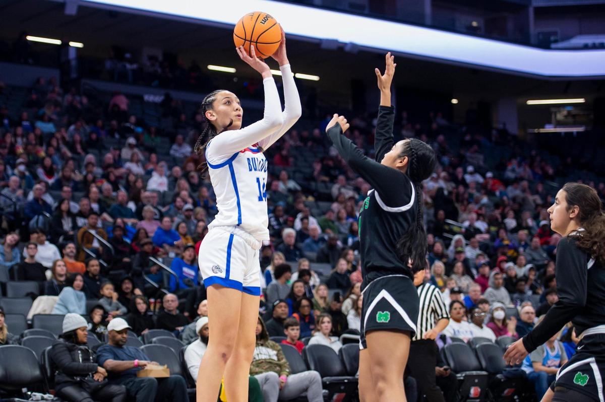 The Folsom Bulldogs’ Kamryn Mafua (14) makes a jump shot over St. Mary’s Rams guard Mia Jamias (14) in the second half in the CIF Sac-Joaquin Section Division I girls basketball championship game on Saturday, Feb. 25, 2023, at Golden 1 Center in Sacramento. Mafua had 10 points. The Bulldogs won 58-53.