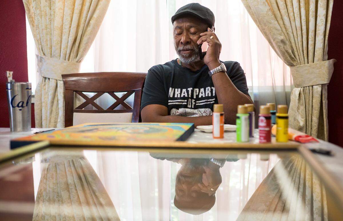 Artist Gary Harrell, who began creating work during his over 40 years behind bars, speaks with a friend still incarcerated at San Quentin State Prison — where Harrell was released in 2020 — on Wednesday, May 10, 2023, from his home in south Sacramento.
