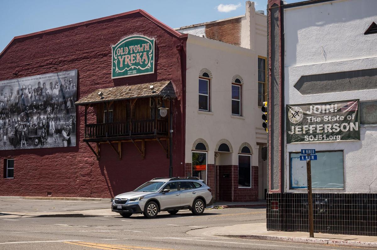 A sign calling for supporters for the State of Jefferson hangs on a building at the intersection of North Main and West Miner streets, across from a sign welcoming people to Old Town Yreka on Aug. 10. Yreka is the Siskiyou County seat county, where about 44% of voters are registered as Republicans and 28% as Democrats.
