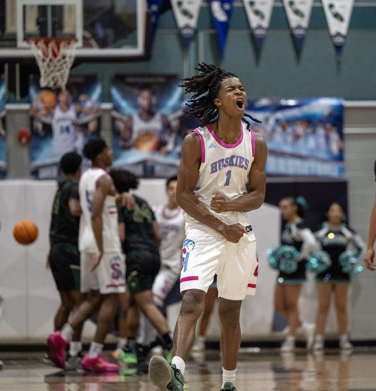 Sheldon Huskies' Baron Sabir (1) reacts after making a three-point shot late in the second half of a game against the Monterey Trail Mustangs on Wednesday.