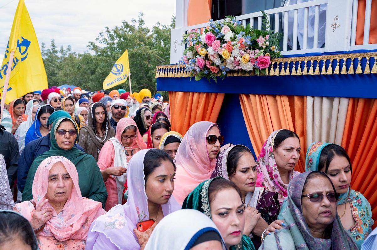 Sikh women march next to the float carrying the holy scripture at the Yuba City Nagar Kirtan parade on Nov. 5, 2023.