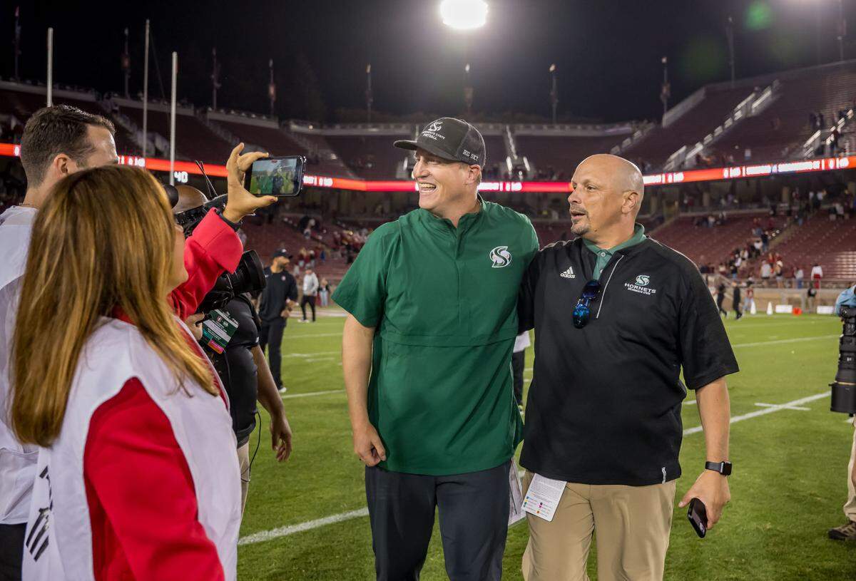 Sacramento State Hornets football coach Andy Thompson and Athletic Director Mark Orr celebrate after their 30-23 win over the Stanford Cardinal in the NCAA college football game Saturday, Sept. 16, 2023, at Stanford University. 