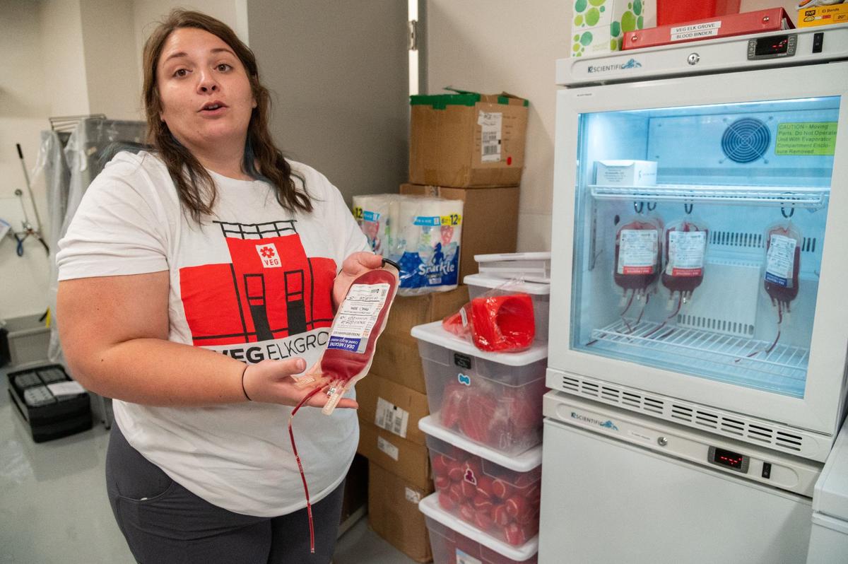 Inventory coordinator Matysen Matthews demonstrates how to agitate a blood bag at the new Veterinary Emergency Group hospital in Elk Grove on Wednesday. Matthews said animals, just like humans, have specific blood types and must therefore be tested and cross matched if they need a blood transfusion.