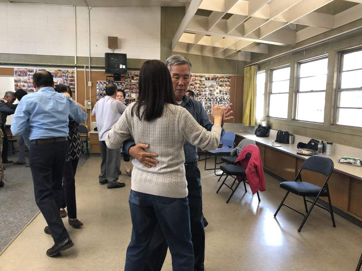 Tam Tran, 78, says tai chi and ballroom dancing classes help him improve his health, and that with music, he feels better as he exercises.