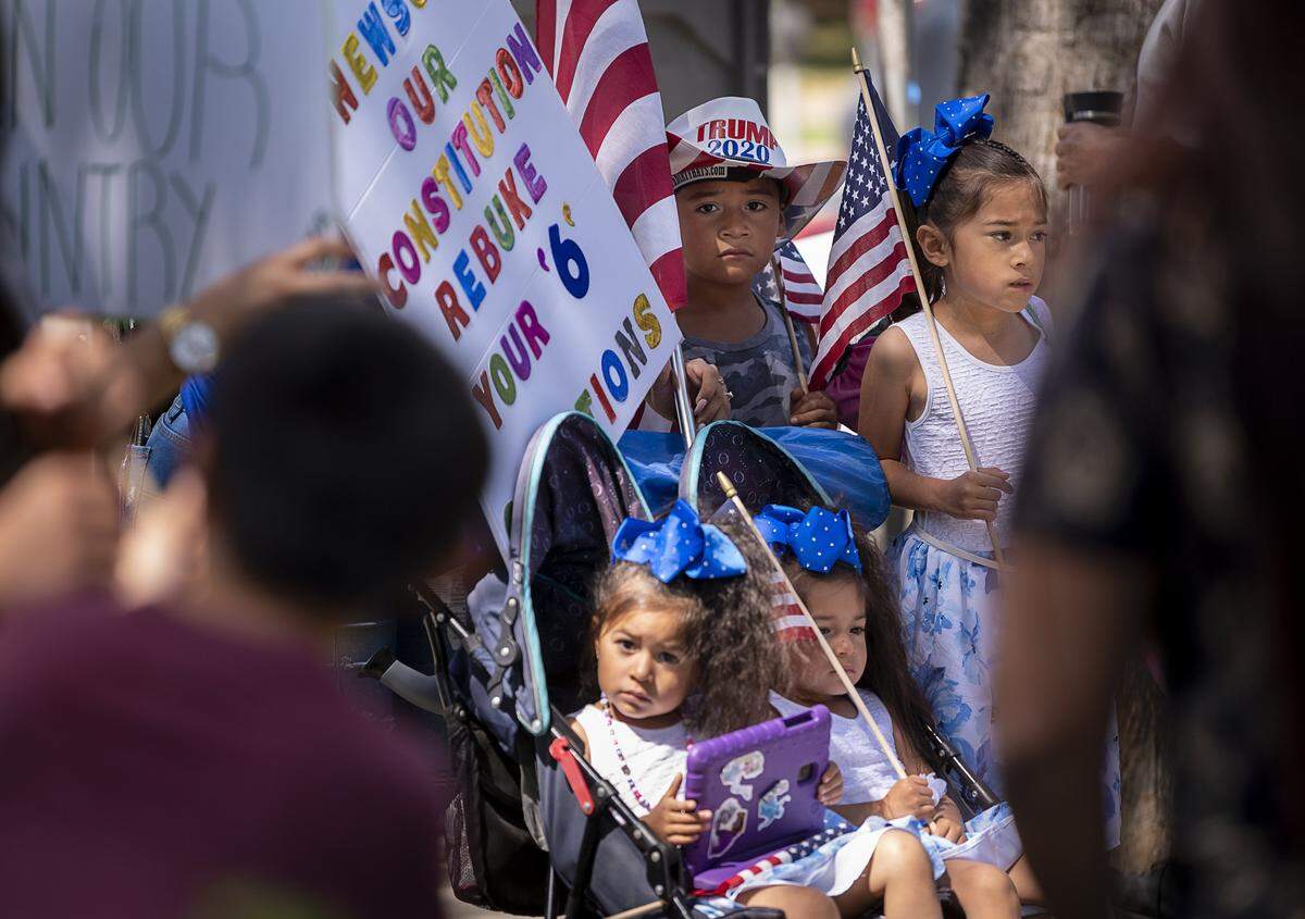 Children attend a protest at the state Capitol on Thursday, May 7, 2020 in Sacramento during the coronavirus pandemic.