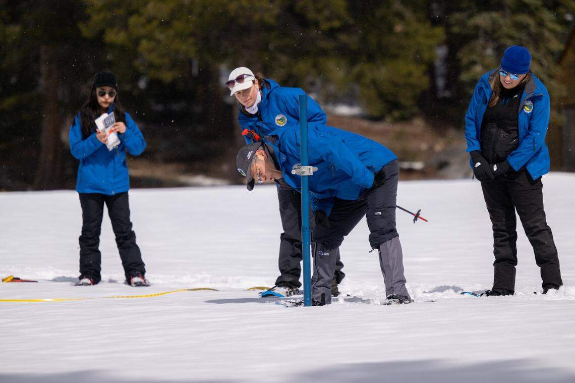 California Department of Water Resources engineer Manon von Kaenel, snow survey manager Andy Reising and hydrometeorologist Angelique Fabbiani-Leon measure the snow in the fourth manual snow survey of the season Friday at Phillips Station in El Dorado County. Statewide, the average snow-water equivalent stood at 23.5 inches, or 90% of the April 1 average.