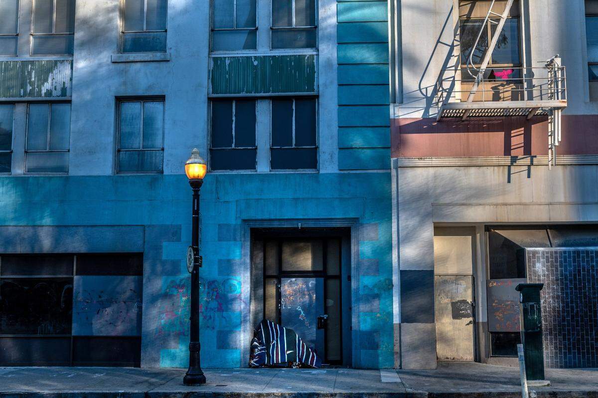 A doorway shelters the homeless on a 10th Street block were many buildings and businesses are closed across from Cesar E. Chavez Plaza in downtown Sacramento on Feb. 17.