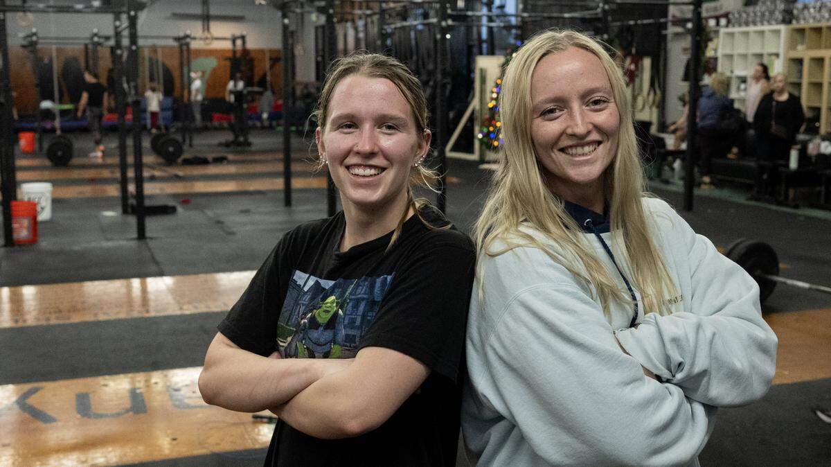 Taylor Mayer, left, stands with her sister Michaela Mayer at AnywhereFit Folsom on Monday. Taylor started a GoFundMe for her sister, who was recently diagnosed with brain cancer. The sisters are both coaches at the gym. 