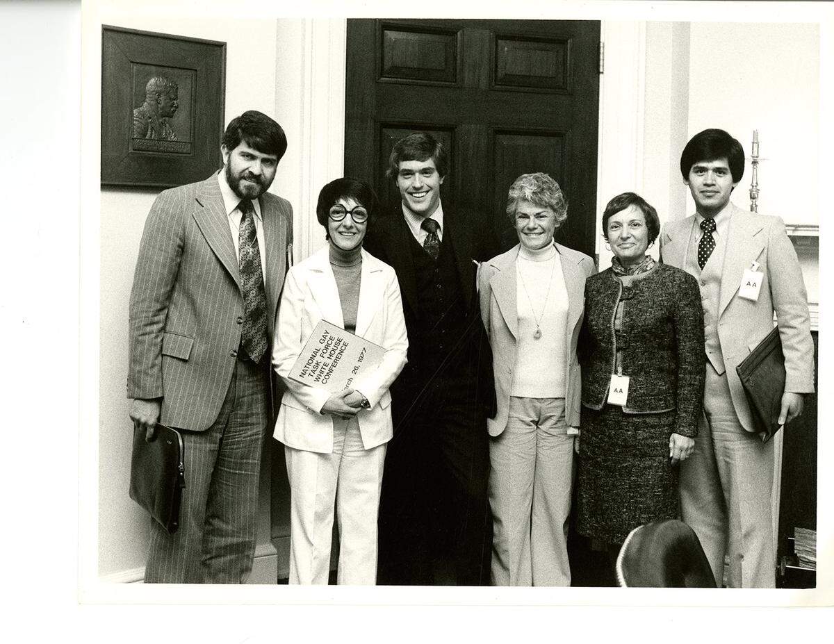 Participants in the March 26, 1977 National Gay Task Force meeting stand with Margaret “Midge” Costanza, who was advisor to President Jimmy Carter.