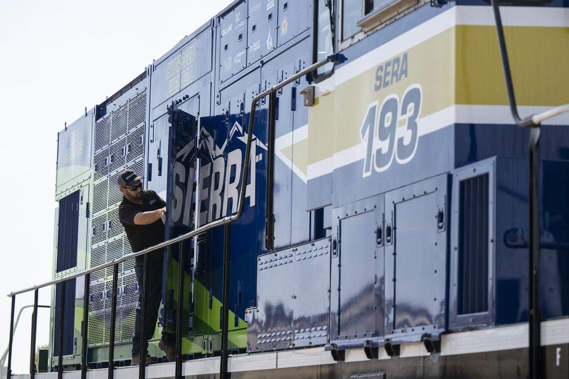 A worker opens the doors on Sierra Northern Railway’s new hydrogen-powered, zero-emission switcher locomotive in West Sacramento on Thursday. According to Sierra Northern Railway, who developed the locomotive, it is the nation’s first of its kind.