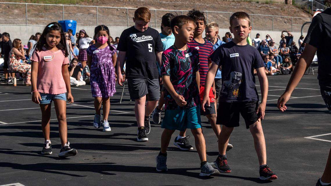 Students walk to their classrooms on the first day of school at Quarry Trail Elementary School in Rocklin in August. A new study reveals that more than 150,000 California children are not receiving a formal education, and enrollment dropped more than 270,000 in the past three years.