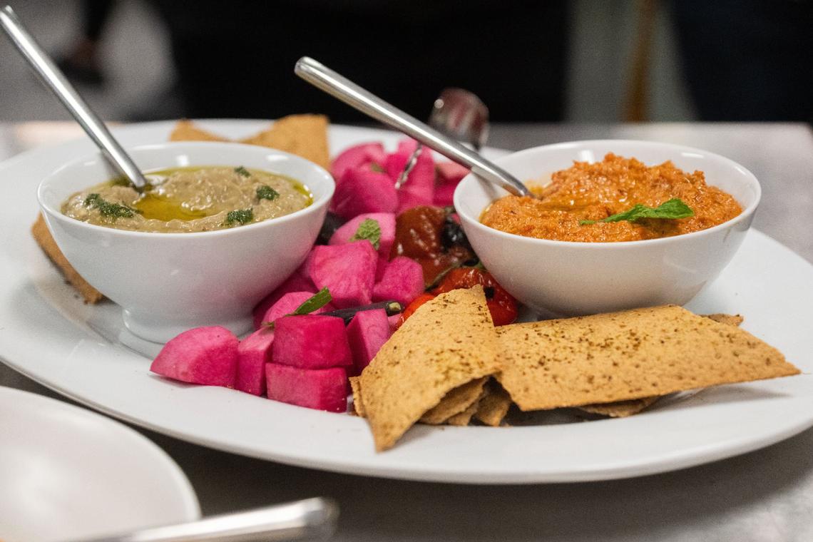 A mezze assortment sits on display during this year’s Tower Bridge Dinner menu preview at the Central Kitchen in Sacramento on Monday. This preset is made with muhammara, torshi pickles, lavash, mutabal and olive oil.
