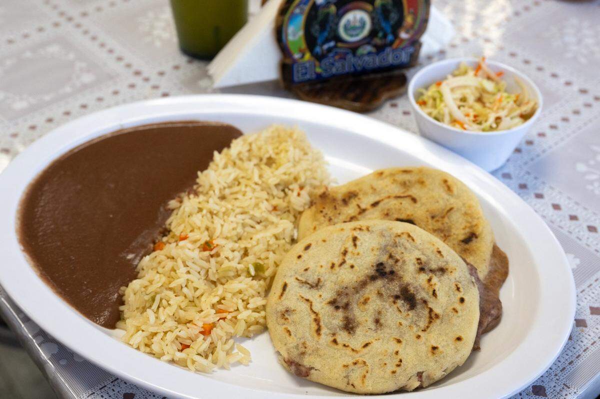 A pupusa combo meal ($11.95), which includes two bean-and-cheese pupusas and a side of beans, red rice and pickled cabbage, is ready to serve at Pupusas Central in Sacramento on Thursday.
