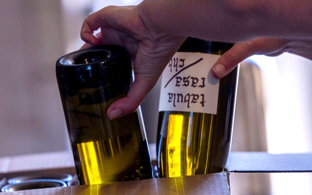 Nicole Dougherty, owner and beverage director of Tabula Rasa Bar in Los Angeles, helps bottle wine at Haarmeyer Wine Cellars in West Sacramento last month.