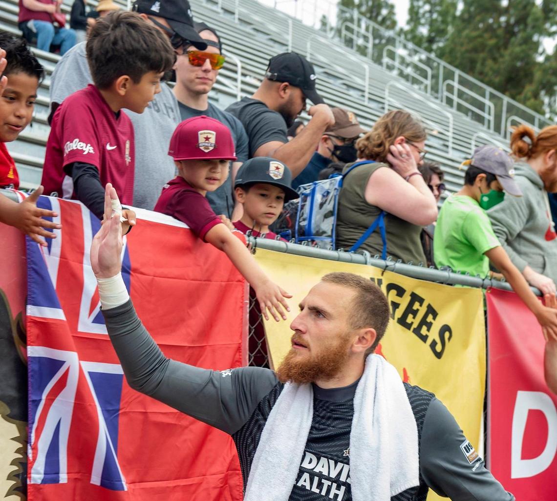Sacramento Republic FC goalkeeper Daniel Vitiello gives high fives to fans after the USL soccer match against Tulsa on Sunday at Heart Health Park.