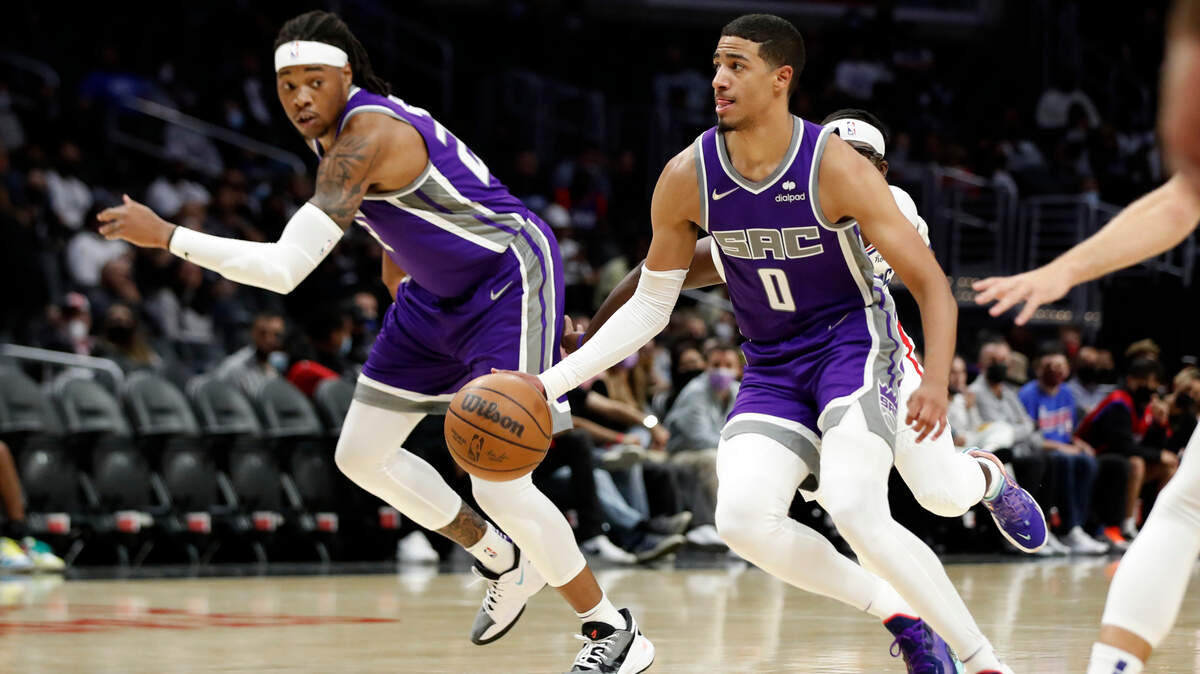 Sacramento Kings guard Tyrese Haliburton (0) goes to the basket with center Richaun Holmes, left, during the first half of a preseason NBA basketball game against the Los Angeles Clippers Wednesday, Oct. 6, 2021, in Los Angeles. (AP Photo/Alex Gallardo)