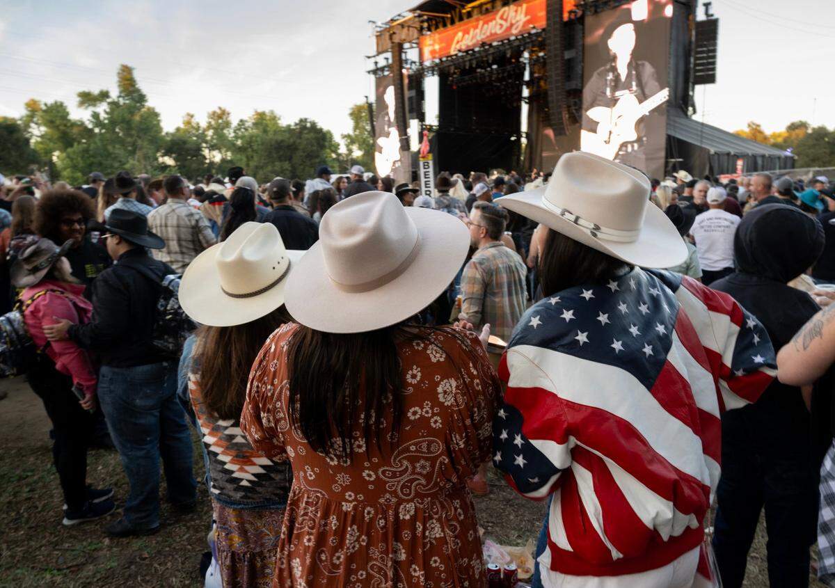 Tammy Mosa, Brooke Toste and Lisa Stephenson of Arroyo Grande listen to Clint Black preform during the GoldenSky Country Music Festival at Discovery Park in Sacramento on Friday, Oct. 18, 2024.