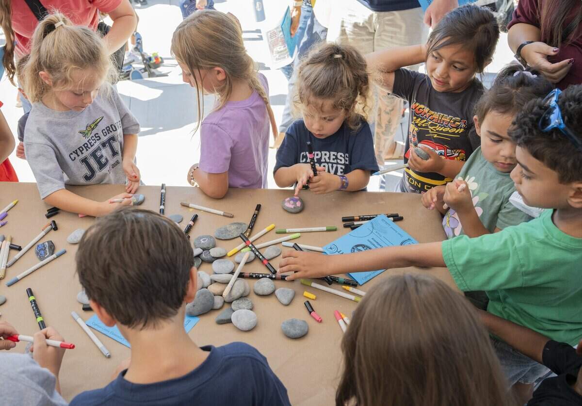 Cypress Grove Elementary School students paint rocks that will be placed around the campus during the school’s grand opening in Rancho Cordova on Tuesday.