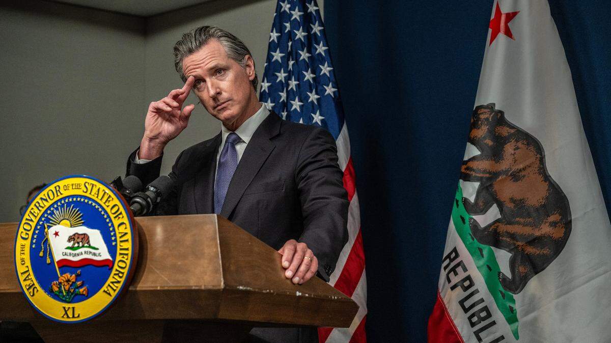 California Gov. Gavin Newsom listens during a press conference after signing his infrastructure streamlining package on July 10 in Sacramento.