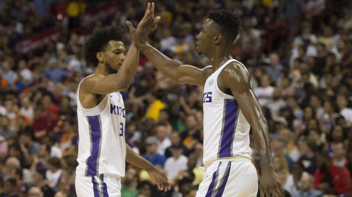 Sacramento Kings forward Marvin Bagley III, left, celebrates a basket with teammate Harry Giles III against the Phoenix Suns in Las Vegas summer league on July 7, 2018. It might be a while before the two see the floor together this season, coach Dave Joerger indicated.